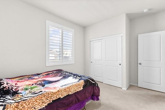 carpeted bedroom with a closet