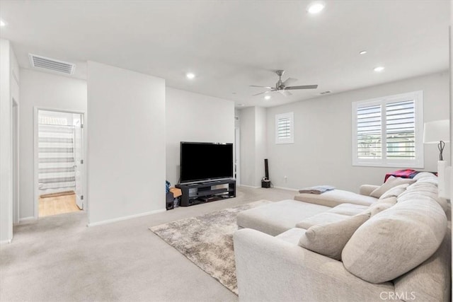 living room with light carpet and ceiling fan