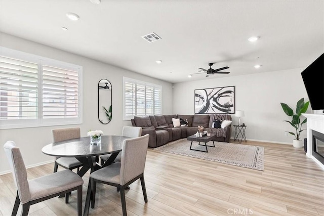 dining room featuring light hardwood / wood-style floors and ceiling fan