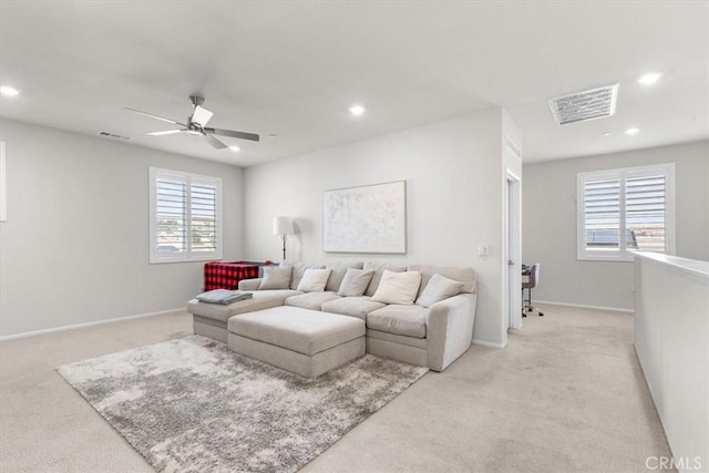 living room featuring ceiling fan and light colored carpet