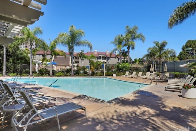 community pool featuring a patio and fence