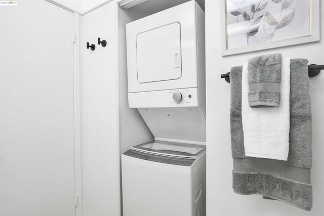 laundry area featuring stacked washing maching and dryer