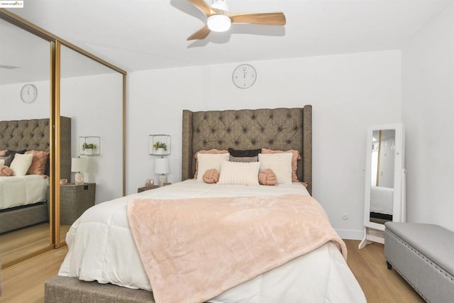 bedroom featuring light wood-type flooring, a closet, and ceiling fan