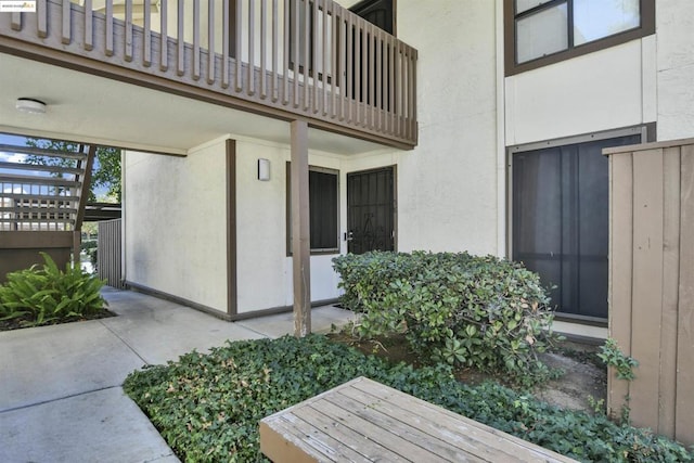 view of exterior entry featuring a balcony