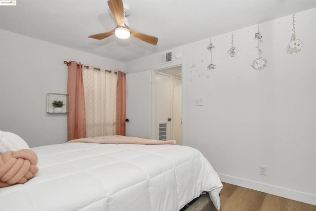 bedroom with ceiling fan and hardwood / wood-style floors