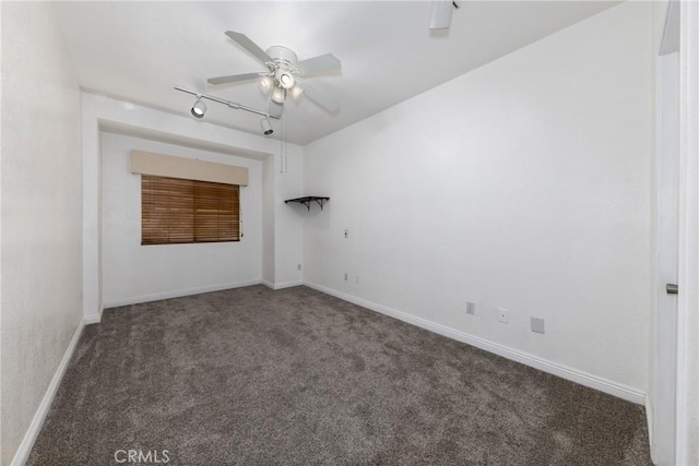 unfurnished room with ceiling fan and dark carpet