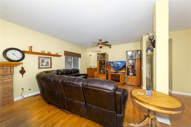 living room featuring ceiling fan and light wood-type flooring