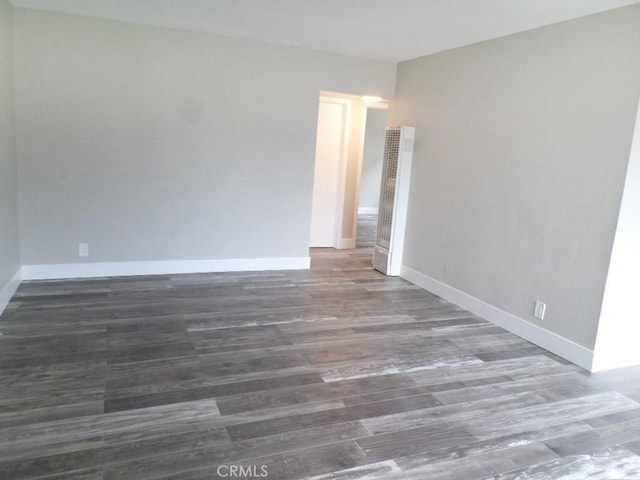 unfurnished room featuring dark hardwood / wood-style flooring