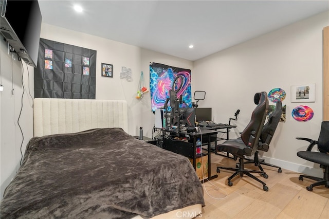 bedroom with hardwood / wood-style flooring and radiator heating unit