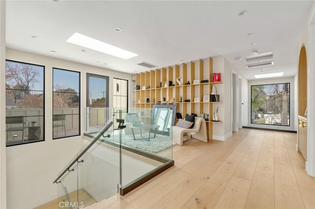 interior space with plenty of natural light and light hardwood / wood-style flooring