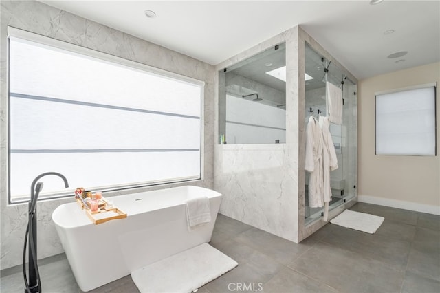 bathroom featuring separate shower and tub and concrete floors