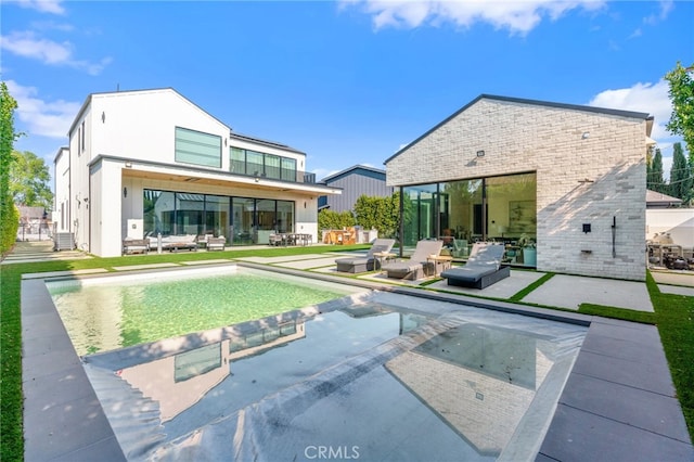 back of property with an outdoor living space, central AC unit, and a patio area