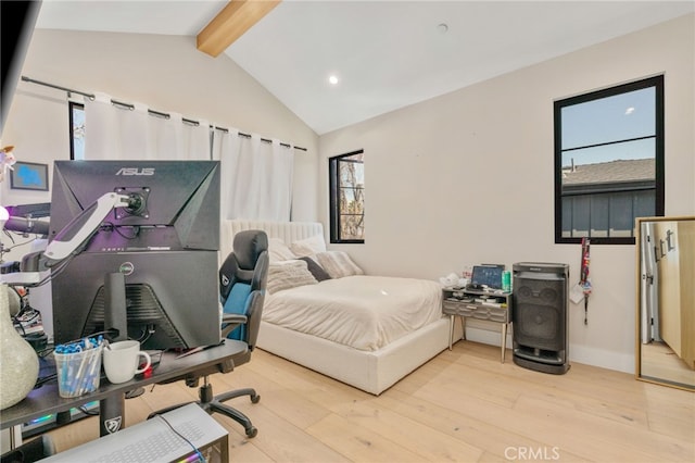 bedroom featuring light hardwood / wood-style floors and vaulted ceiling with beams