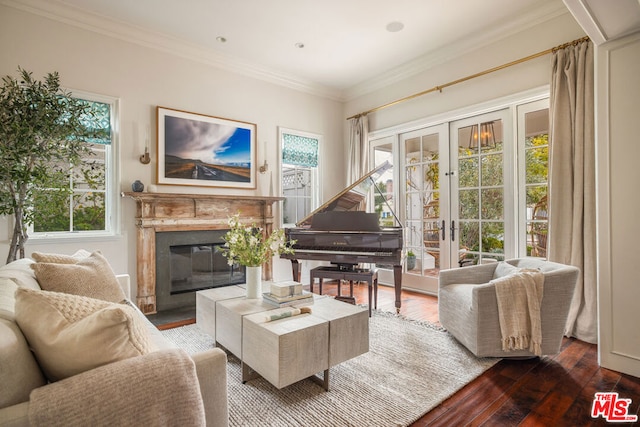 sitting room with a premium fireplace, crown molding, wood-type flooring, and french doors