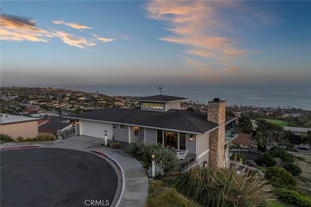 view of front of home with a water view