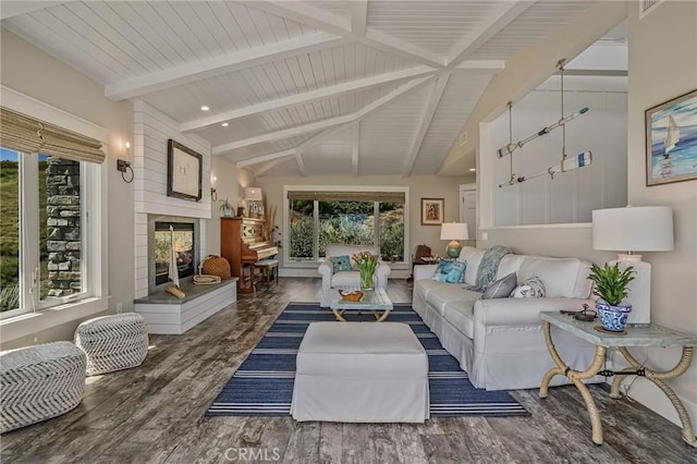 interior space with lofted ceiling with beams and a large fireplace