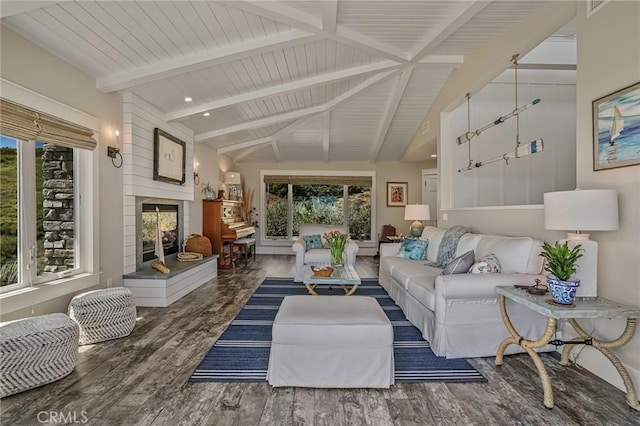 living area featuring a multi sided fireplace, vaulted ceiling with beams, and wood finished floors