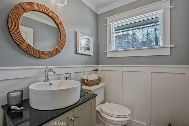 bathroom featuring ornamental molding, toilet, and vanity