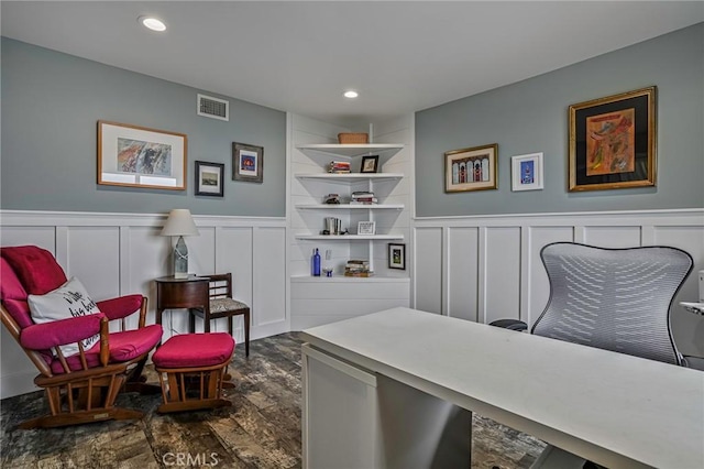 office space with dark hardwood / wood-style flooring and built in shelves