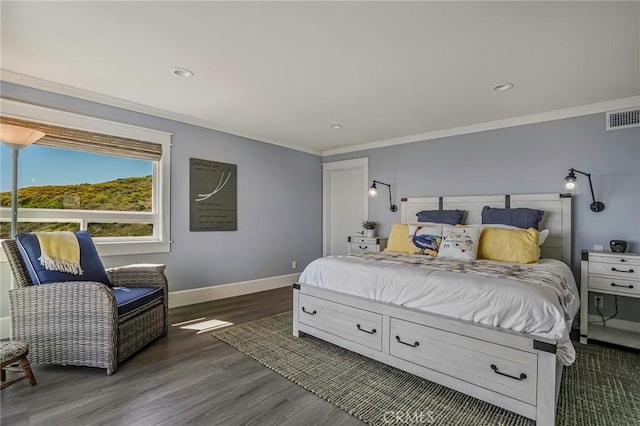 bedroom with crown molding and dark hardwood / wood-style flooring