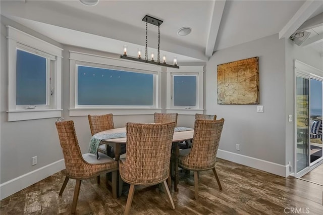 dining room featuring beamed ceiling and hardwood / wood-style flooring