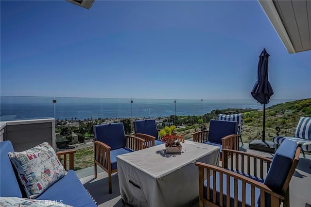 exterior space with an outdoor living space, a water view, and a balcony