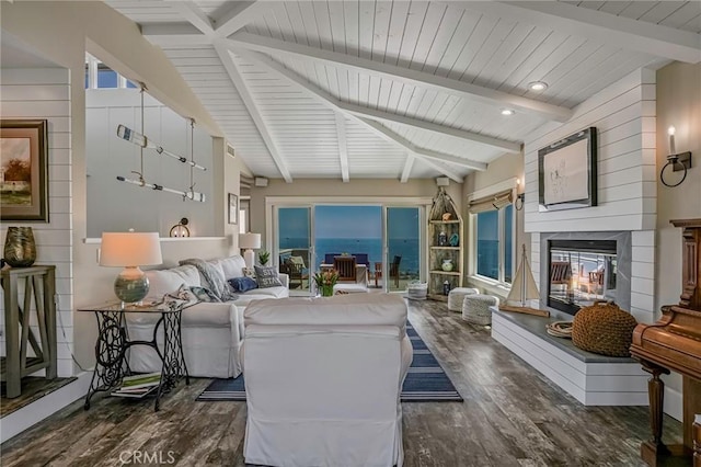 living room with lofted ceiling with beams, a multi sided fireplace, and dark wood-type flooring