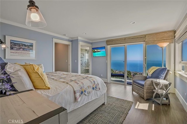 bedroom featuring crown molding, wood-type flooring, and access to exterior