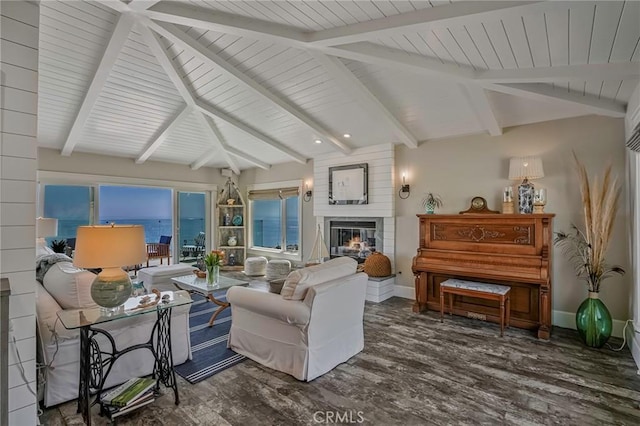 living room with a water view, a large fireplace, dark hardwood / wood-style floors, and beamed ceiling