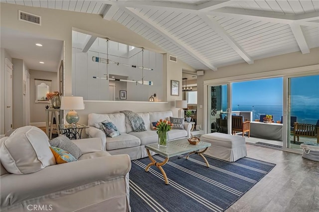 living area featuring visible vents, recessed lighting, wood finished floors, and vaulted ceiling with beams