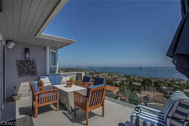 view of patio with a water view, an outdoor living space, and a balcony