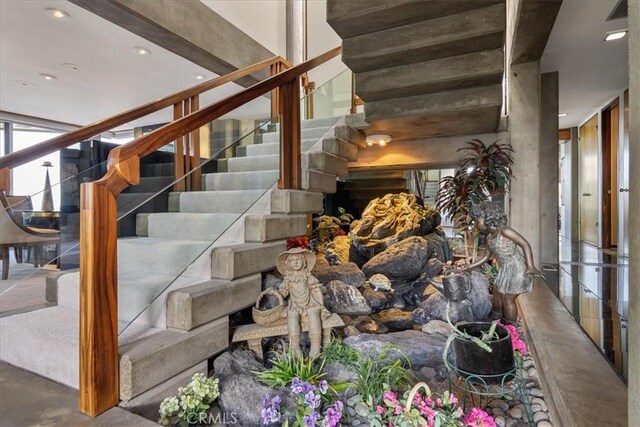 stairway featuring concrete floors