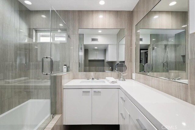 bathroom featuring vanity and plus walk in shower