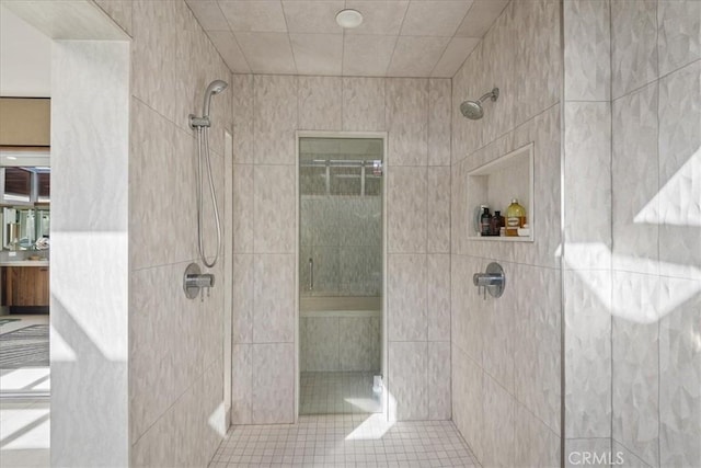 bathroom featuring tiled shower and tile patterned floors