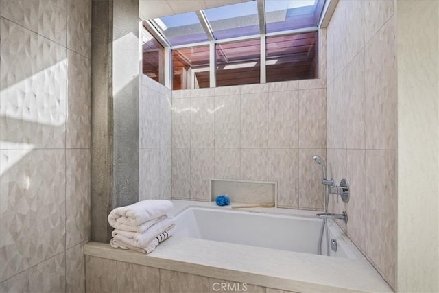 bathroom featuring plenty of natural light and independent shower and bath