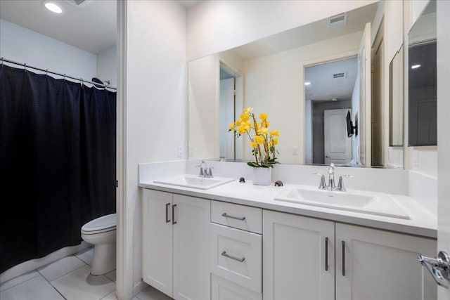 bathroom with toilet, tile patterned floors, and vanity