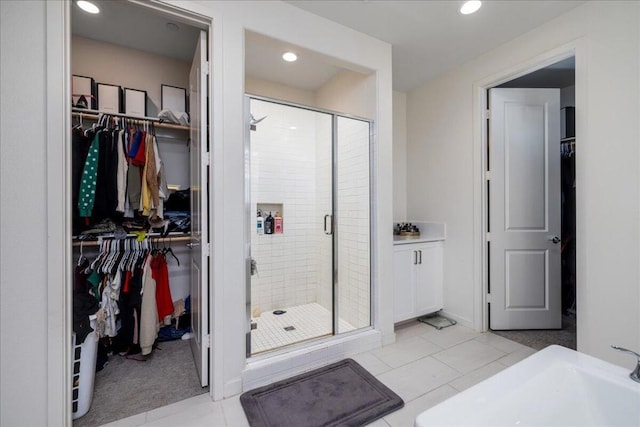 bathroom featuring a shower with shower door and tile patterned floors