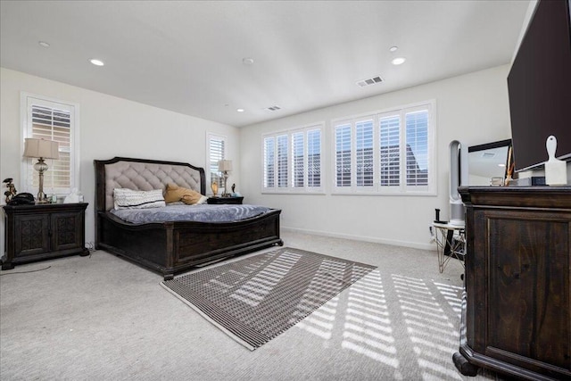 carpeted bedroom featuring multiple windows