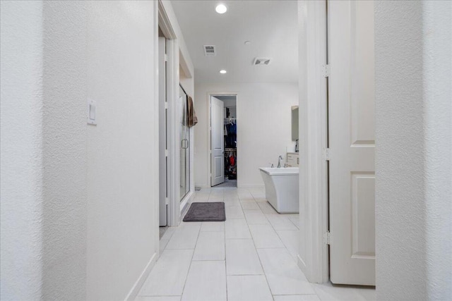 corridor with light tile patterned floors