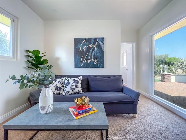 living room featuring carpet flooring and a healthy amount of sunlight