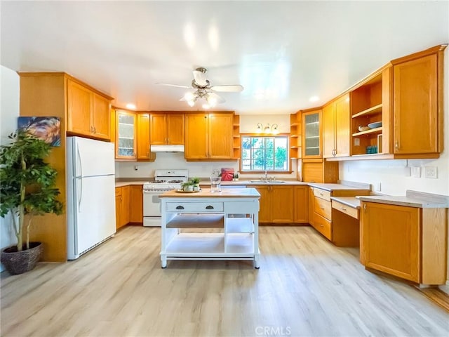 kitchen with sink, ceiling fan, white appliances, and light hardwood / wood-style floors