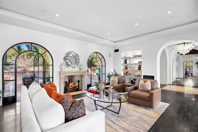 living room featuring hardwood / wood-style floors and built in features