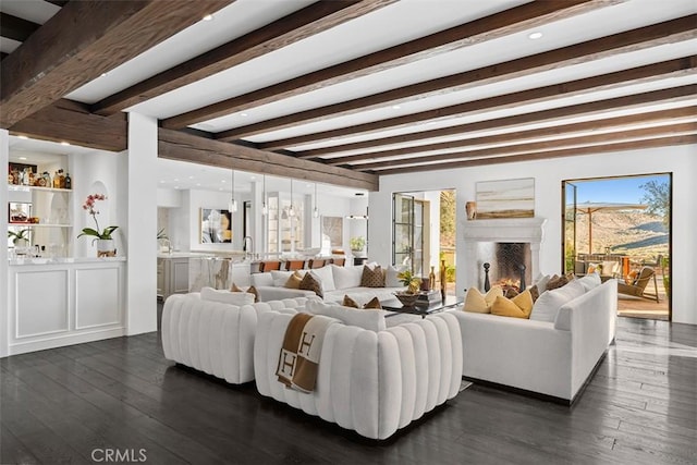 living room featuring beamed ceiling and dark hardwood / wood-style flooring