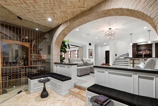 wine room with light parquet flooring and a chandelier