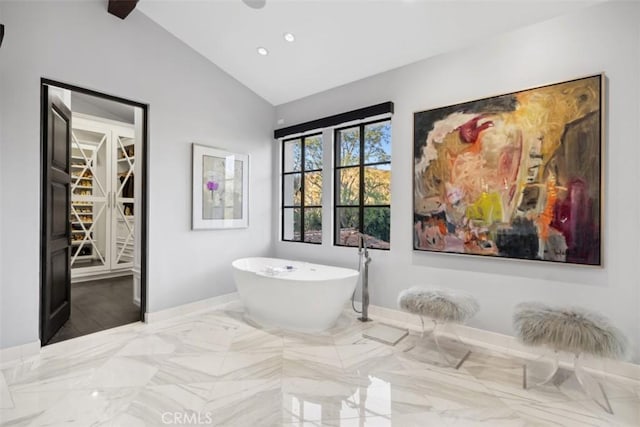 bathroom with vaulted ceiling and a bathing tub