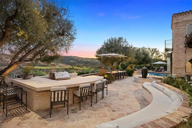 patio terrace at dusk with exterior bar