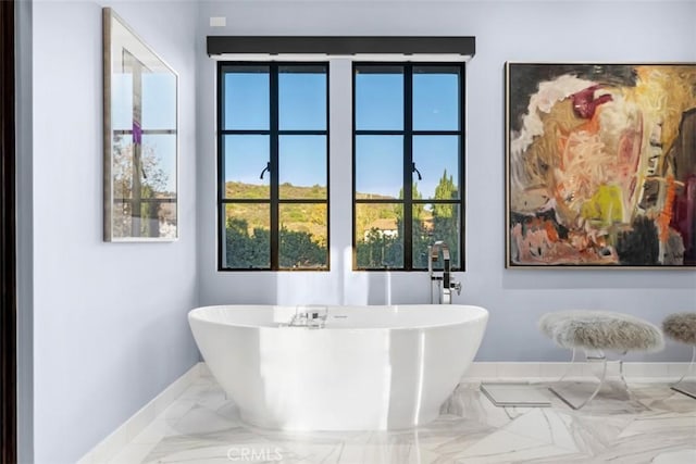 bathroom with a tub to relax in