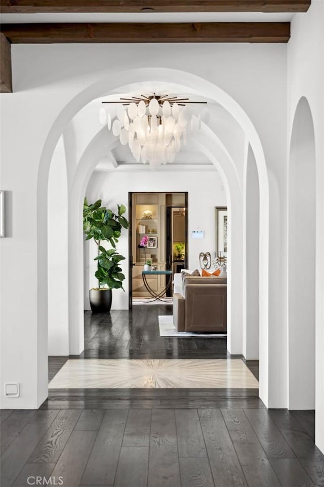 corridor with dark hardwood / wood-style floors and beam ceiling