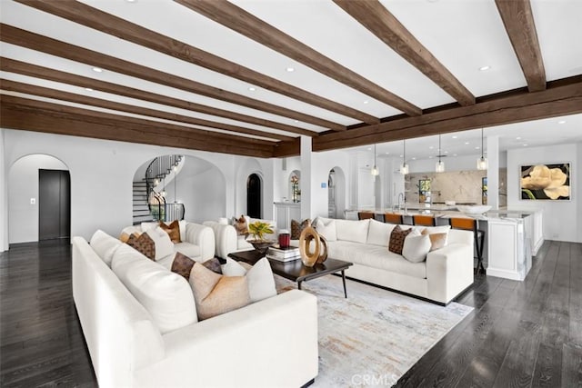 living room with beamed ceiling and dark hardwood / wood-style floors