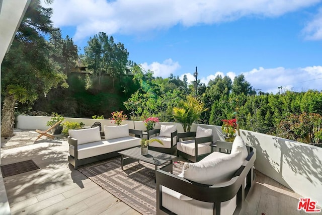 wooden terrace with outdoor lounge area